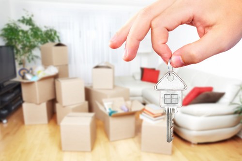 Professional movers handling furniture and office items during relocation
