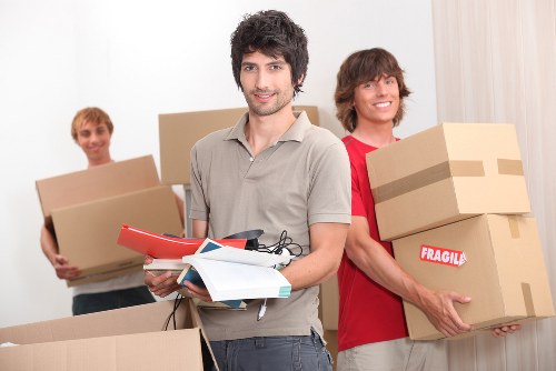 Removal team handling furniture during a house move in Slough