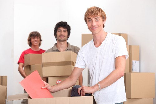 Organized storage unit in Slough with labeled boxes and furniture